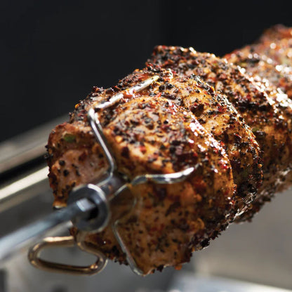 Grilled meat skewer on a metal skewer against a dark background