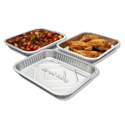 Three compartmentalized aluminum food containers with food on a white background