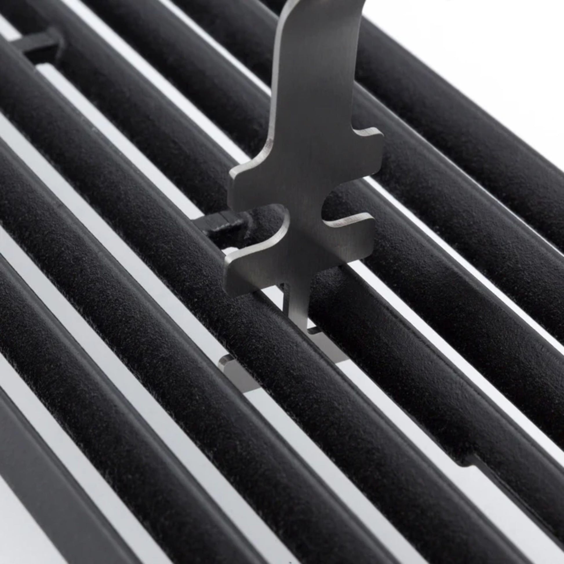 Close-up of a black metal grill with a grid lifter component.