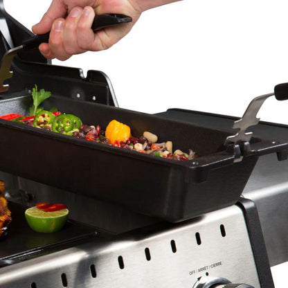Person grilling vegetables on a portable grill pan with a white background