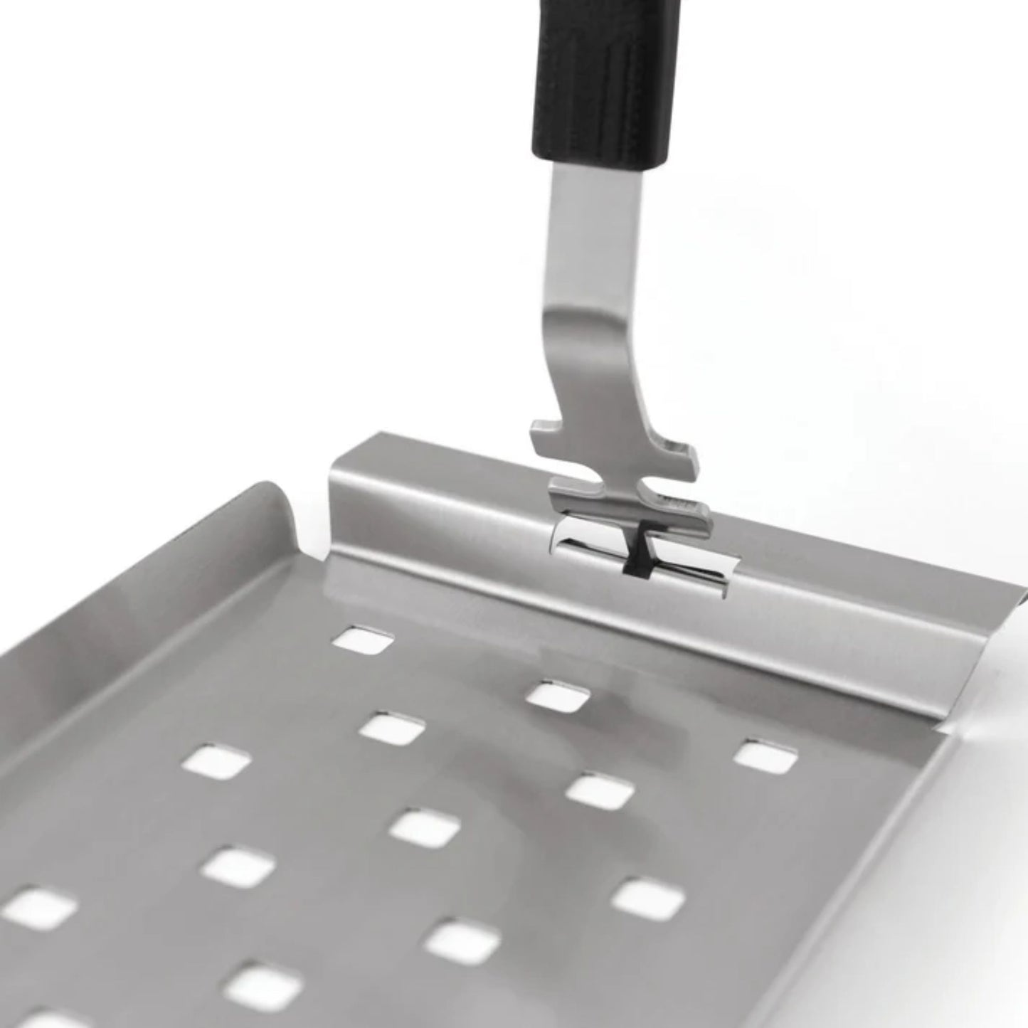 Metal spatula with perforated design on a white background