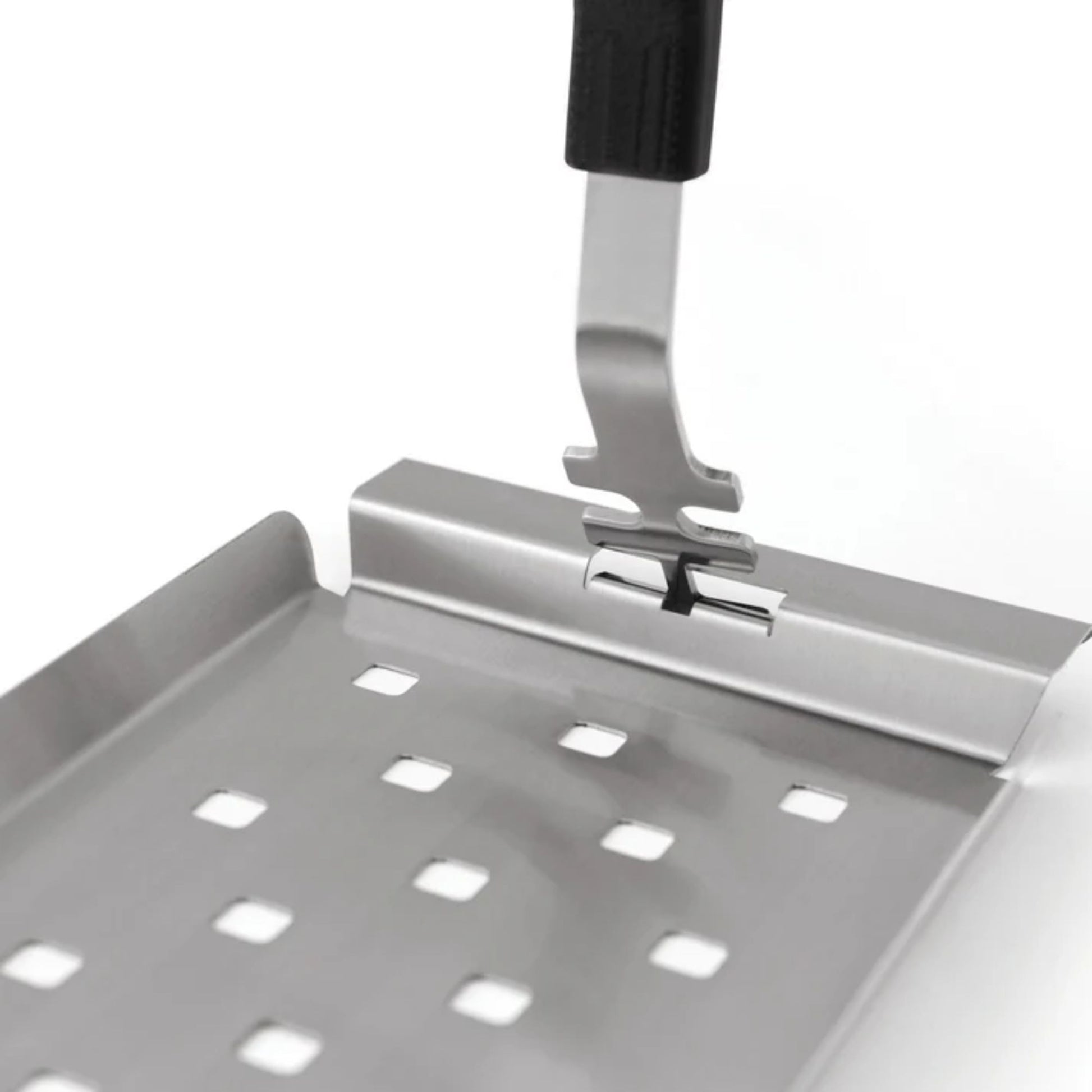 Metal spatula with perforated design on a white background