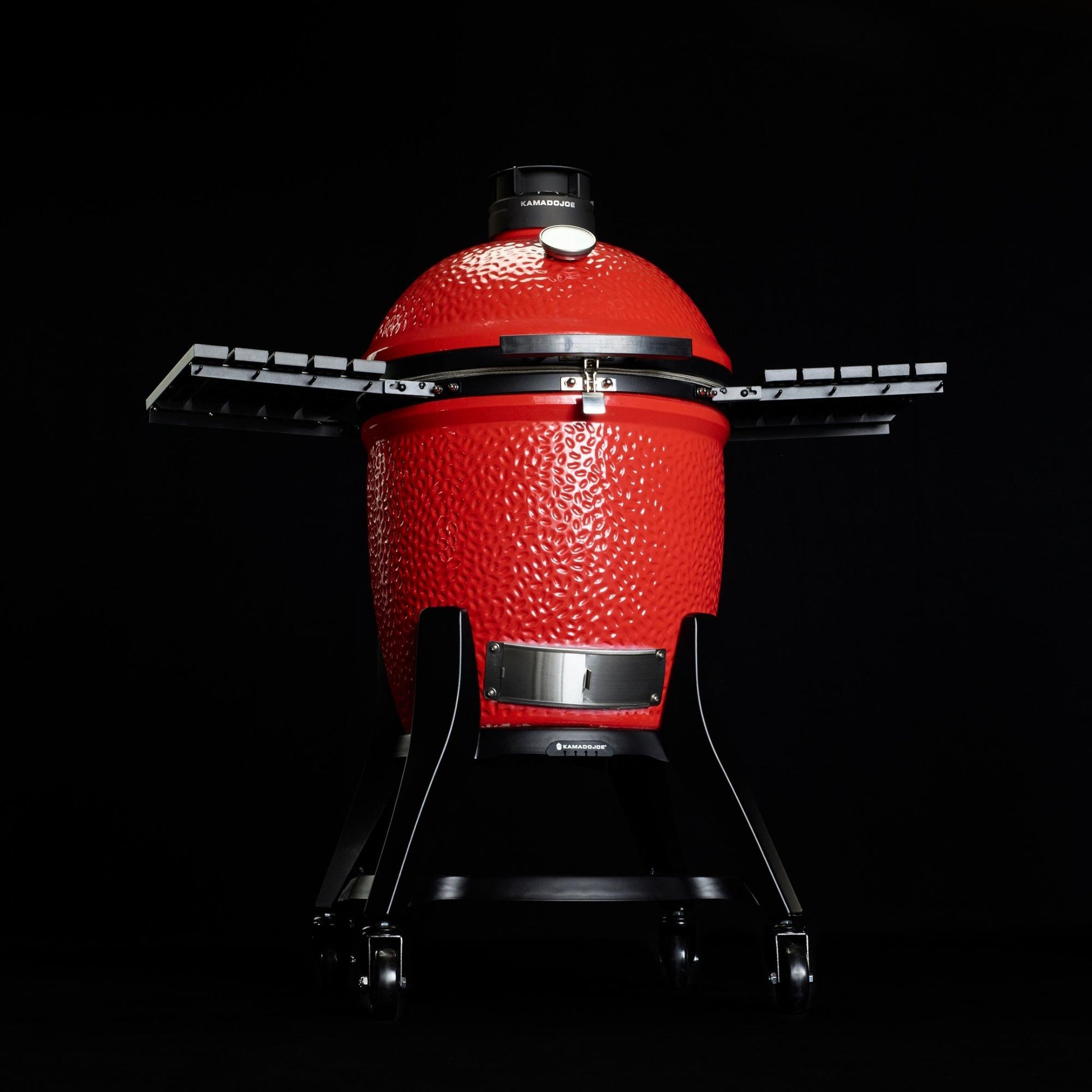 Kamadoe Joe BBQ with stand on a black background.