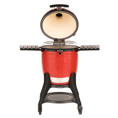 Red ceramic barbecue grill with black stand on a white background
