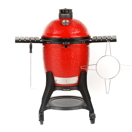 Red Kamado grill with black stand on a white background