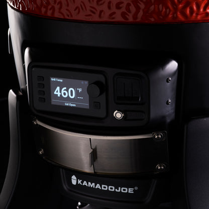 Close-up of a Kamado Joe grill with digital temperature display on a dark background