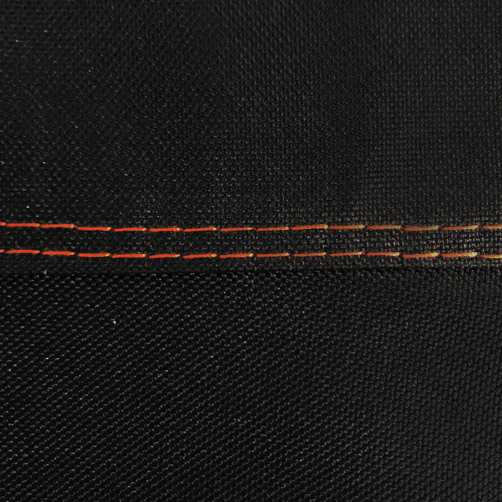 Close-up of black fabric with red stitching detail
