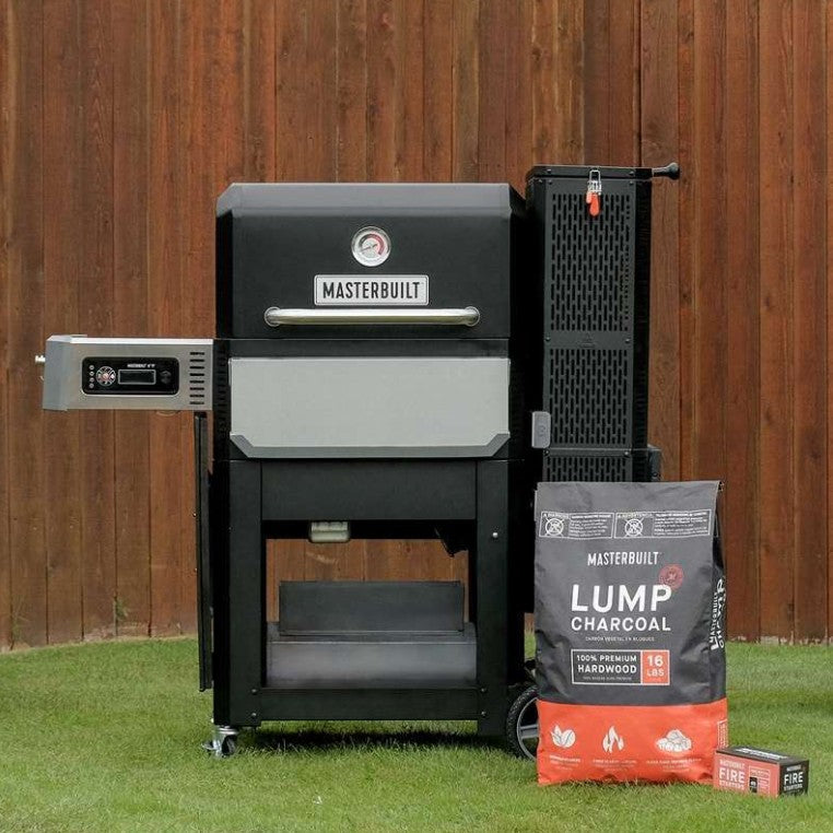 Masterbuilt barbecue grill with accessories on a grassy area against a wooden fence.
