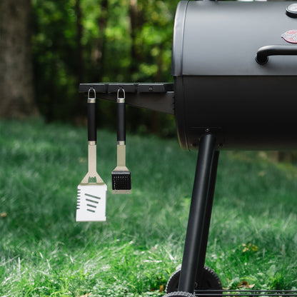 Black barbecue grill with a tool holder on grass