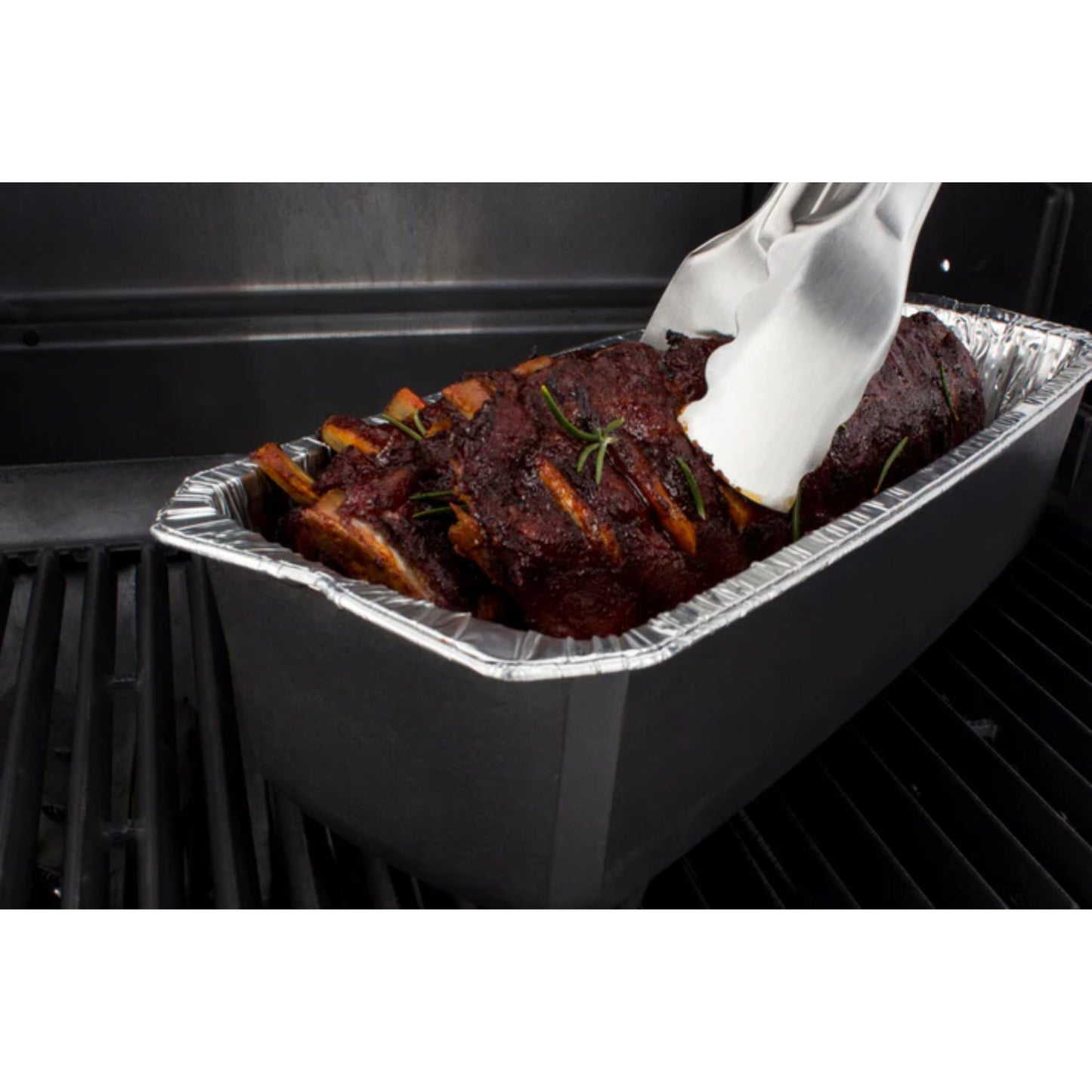 Aluminum pan with ribs being placed into an oven