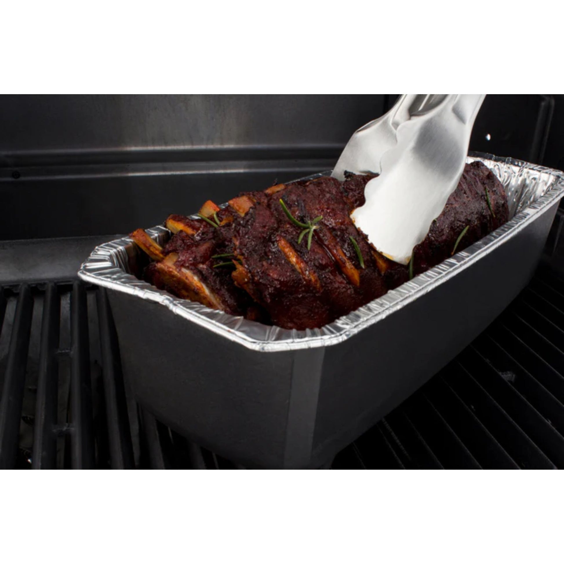 Aluminum pan with ribs being placed into an oven