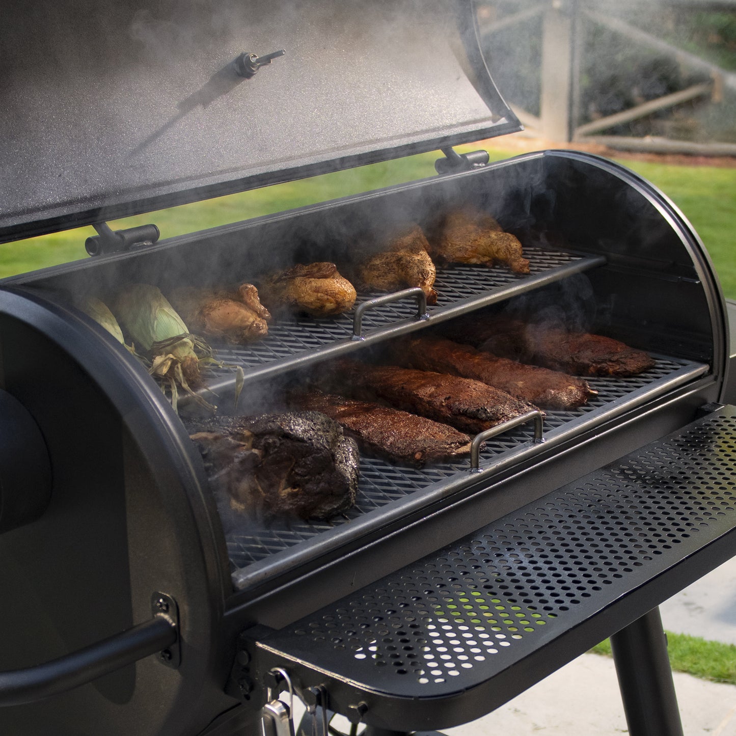Barbecue grill with food cooking on a patio
