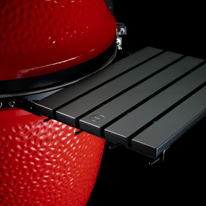 Black grill grate attached to a red barbecue grill