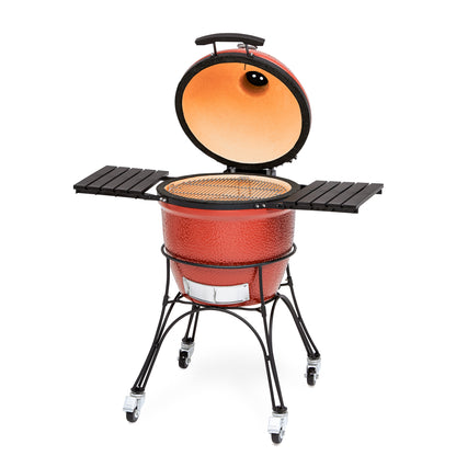 Red ceramic grill with open lid on a white background