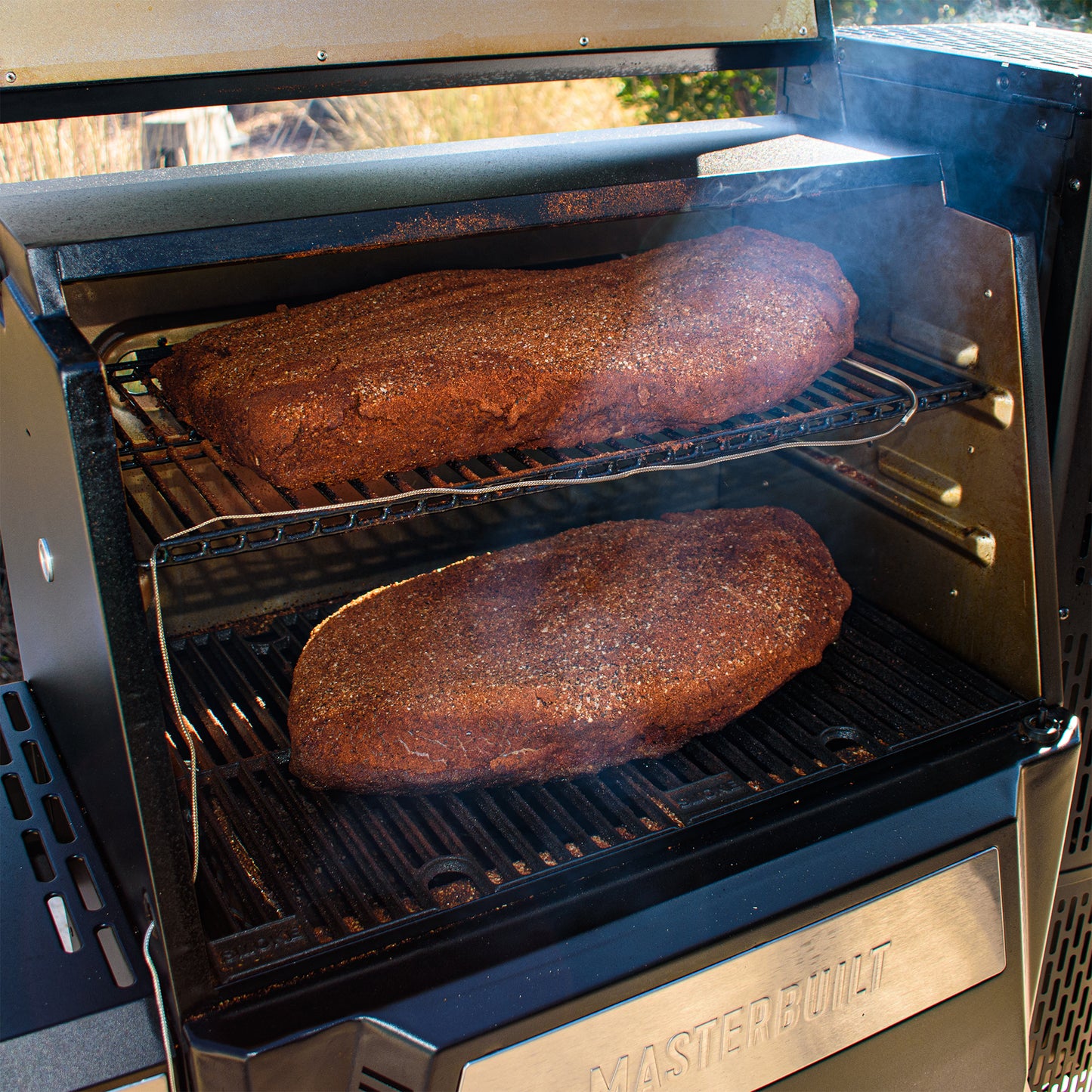 Meat cooking inside a Masterbuilt smoker.