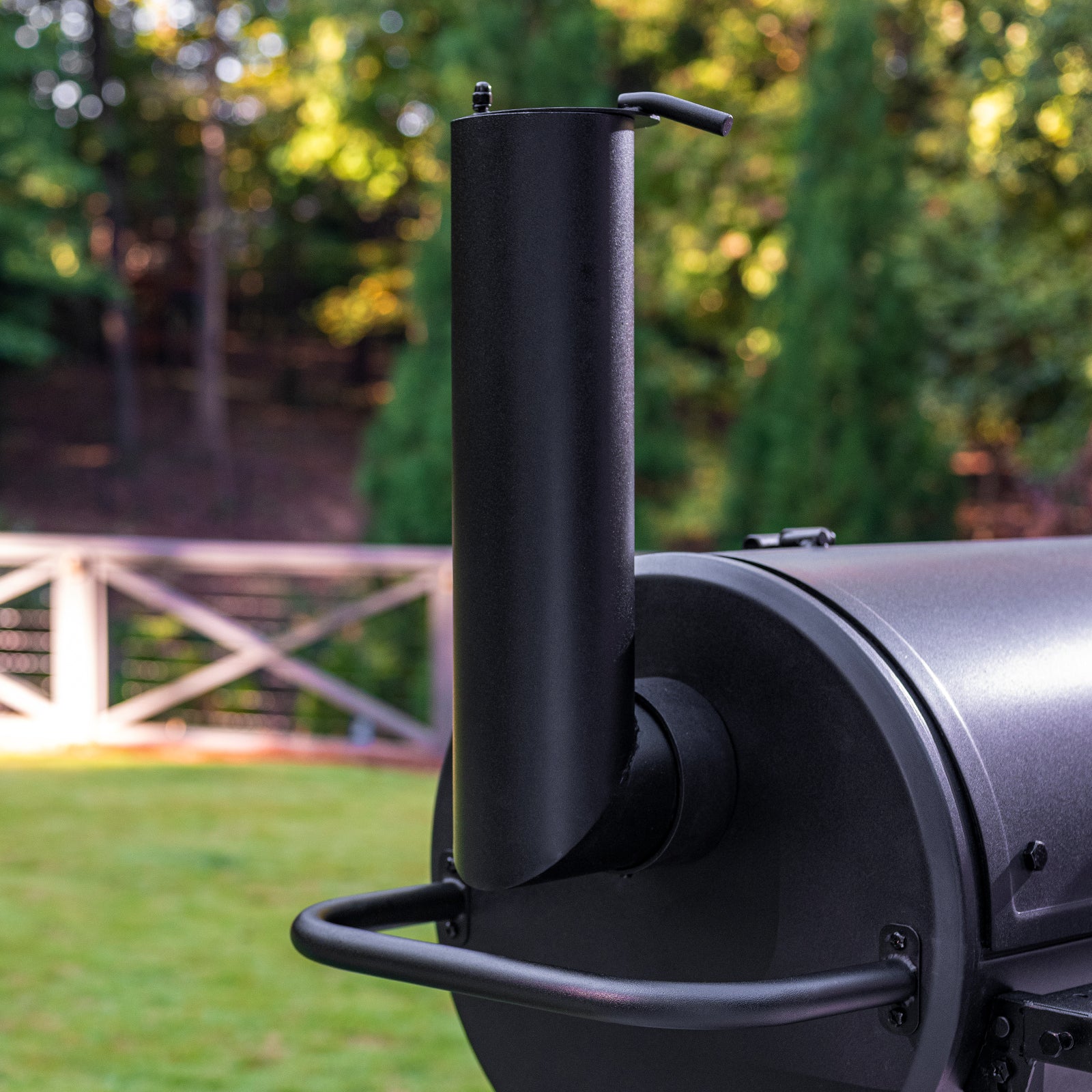 Barbecue grill with a chimney in an outdoor setting