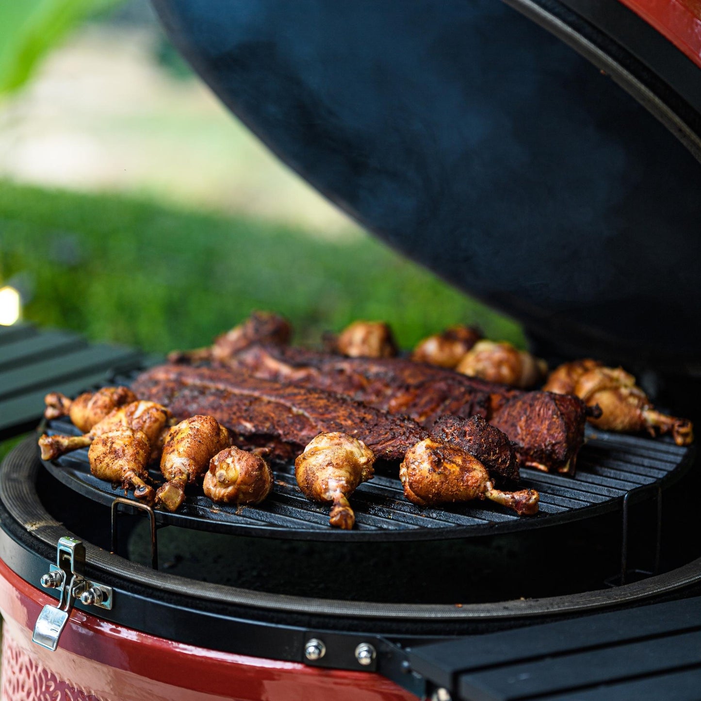Barbecue with ribs and chicken on a grill outdoors