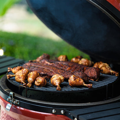 Barbecue with ribs and chicken on a grill outdoors