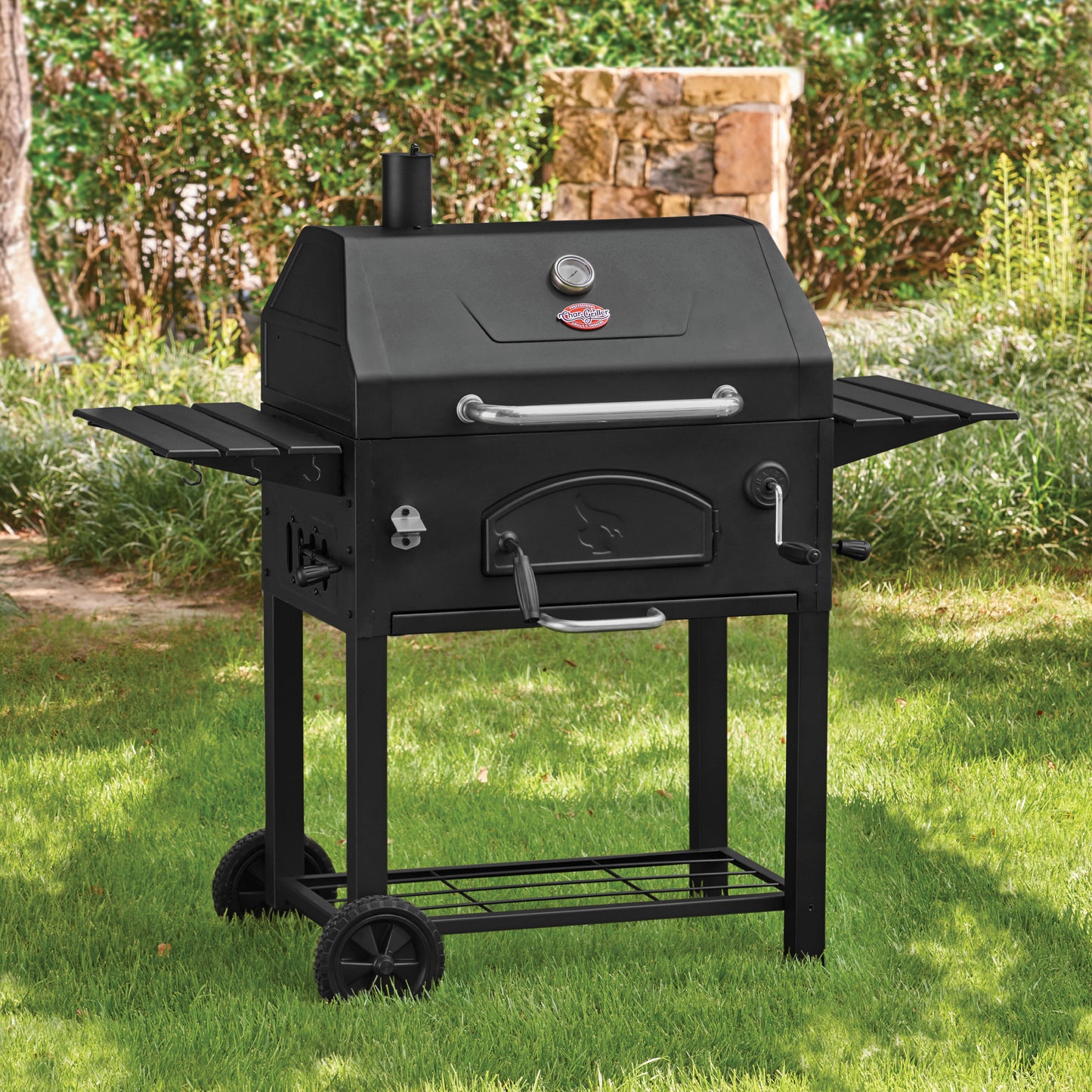 Black barbecue grill on grass with a scenic background