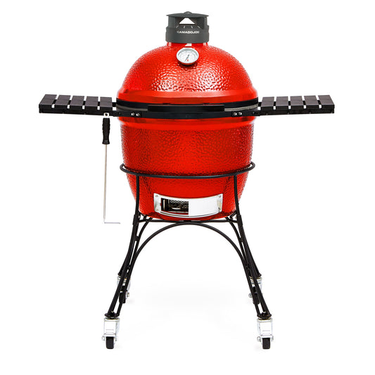 Red Kamado-style grill with black stand on a white background